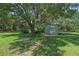 View of metal storage shed and other yard storage structures on a grassy lot at 18166 Lynbrook Rd, Orlando, FL 32820