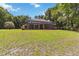Spacious backyard featuring a covered patio and lush green lawn at 21795 Sw 88Th Lane Rd, Dunnellon, FL 34431