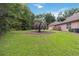 Beautifully landscaped backyard with a large, mature palm tree at 21795 Sw 88Th Lane Rd, Dunnellon, FL 34431