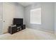 Clean bedroom with carpet, a simple entertainment center, and a ceiling fan at 21795 Sw 88Th Lane Rd, Dunnellon, FL 34431