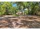 Scenic driveway leading to a charming one-story home surrounded by mature trees and lush landscaping at 21795 Sw 88Th Lane Rd, Dunnellon, FL 34431