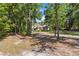 Scenic view of a charming one-story home surrounded by mature trees and lush landscaping at 21795 Sw 88Th Lane Rd, Dunnellon, FL 34431