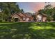 Charming one-story home featuring lush landscaping and a well-manicured lawn with a lamp post in the front yard at 21795 Sw 88Th Lane Rd, Dunnellon, FL 34431