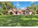 Charming one-story home featuring lush landscaping and a well-manicured lawn and a beautifully maintained facade at 21795 Sw 88Th Lane Rd, Dunnellon, FL 34431