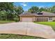 Attached two-car garage with a concrete driveway at 21795 Sw 88Th Lane Rd, Dunnellon, FL 34431