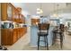 Open kitchen boasts a breakfast bar and wooden cabinets at 21795 Sw 88Th Lane Rd, Dunnellon, FL 34431