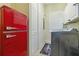 Convenient laundry room with washer, dryer, and vintage refrigerator at 21795 Sw 88Th Lane Rd, Dunnellon, FL 34431