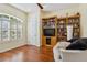 Cozy living room with hardwood floors, built-in shelving, and lots of natural light at 21795 Sw 88Th Lane Rd, Dunnellon, FL 34431