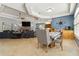 Open living space with a dining area, blue accent wall, and lots of seating at 21795 Sw 88Th Lane Rd, Dunnellon, FL 34431