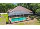 Backyard pool area featuring a screened-in enclosure, perfect for relaxing or entertaining at 21795 Sw 88Th Lane Rd, Dunnellon, FL 34431