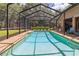 Large, screened-in pool is surrounded by mature trees at 21795 Sw 88Th Lane Rd, Dunnellon, FL 34431