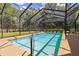 Inviting pool surrounded by a screened enclosure at 21795 Sw 88Th Lane Rd, Dunnellon, FL 34431