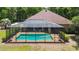 Backyard pool area featuring a screened-in enclosure, perfect for relaxing or entertaining at 21795 Sw 88Th Lane Rd, Dunnellon, FL 34431