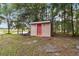 Exterior view of storage shed surrounded by trees at 21795 Sw 88Th Lane Rd, Dunnellon, FL 34431