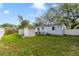 View of the home's backyard with a white fence and storage shed at 220 Colony Pl, Casselberry, FL 32707