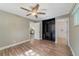 Bedroom featuring wood-look floors, a ceiling fan, and access to both a closet and the bathroom at 220 Colony Pl, Casselberry, FL 32707