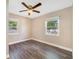 Bedroom featuring wood floors and two bright windows at 220 Colony Pl, Casselberry, FL 32707