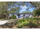 Charming single-story home with mature trees and a well-maintained front lawn at 220 Colony Pl, Casselberry, FL 32707