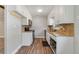 Classic kitchen featuring white cabinets, granite countertops, and modern appliances at 220 Colony Pl, Casselberry, FL 32707