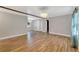 Open-concept living room with wood floors and great natural light from the large window at 220 Colony Pl, Casselberry, FL 32707