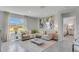 A bright living room features neutral furniture, accent rug, and an abundance of natural light at 2249 Lake Preserve Cir, New Smyrna Beach, FL 32168