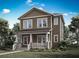 Charming two-story home showcasing a covered front porch and inviting curb appeal at 2486 Celebration Blvd, Celebration, FL 34747