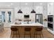 Modern kitchen features white cabinetry, a spacious island with seating, and stainless steel appliances at 2486 Celebration Blvd, Celebration, FL 34747
