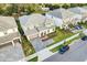 A high-angle shot showing this house with neutral paint, driveway, landscaping, and neighborhood at 2537 Shanti Dr, Kissimmee, FL 34746