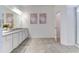 Modern bathroom with a double vanity, granite countertop, and an enclosed shower at 2537 Shanti Dr, Kissimmee, FL 34746