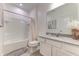 Bright bathroom featuring a shower and tub combination and a white single sink vanity with gray countertops at 2537 Shanti Dr, Kissimmee, FL 34746