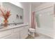 Bright bathroom featuring a shower and tub combination and a white single sink vanity with gray countertops at 2537 Shanti Dr, Kissimmee, FL 34746