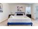 Comfortable bedroom with a blue bed frame, neutral walls, and modern side tables at 2537 Shanti Dr, Kissimmee, FL 34746