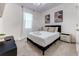 Cozy bedroom with modern artwork, natural light from the window, and a minimalist aesthetic at 2537 Shanti Dr, Kissimmee, FL 34746