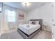 Comfortable bedroom featuring a bed, soft carpet flooring, natural light and a decorative painting at 2537 Shanti Dr, Kissimmee, FL 34746