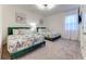 Bright bedroom featuring two beds with decorative quilts, and soft carpet flooring with natural light at 2537 Shanti Dr, Kissimmee, FL 34746
