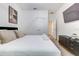 Well-lit bedroom featuring neutral decor, a comfortable bed, and a sleek dresser at 2537 Shanti Dr, Kissimmee, FL 34746