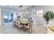 Bright dining room features sliding glass doors to the backyard patio and a modern chandelier at 2537 Shanti Dr, Kissimmee, FL 34746