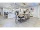 Dining room area with a large table, seating for eight, and modern light fixtures at 2537 Shanti Dr, Kissimmee, FL 34746