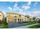 Beautiful two-story home with a two car garage and a landscaped front yard under a partly cloudy sky at 2537 Shanti Dr, Kissimmee, FL 34746