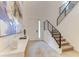 Inviting foyer with staircase, modern decor, tiled floors, and ample natural light at 2537 Shanti Dr, Kissimmee, FL 34746