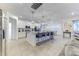 Modern kitchen featuring a center island with seating, stainless steel appliances, and white cabinetry at 2537 Shanti Dr, Kissimmee, FL 34746