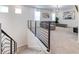 Open-concept living room viewed from the stairs, featuring stylish furniture and modern railing at 2537 Shanti Dr, Kissimmee, FL 34746