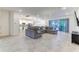 Open-concept living room featuring tile floors, a large sectional couch, and sliding glass doors to the backyard at 2537 Shanti Dr, Kissimmee, FL 34746