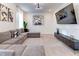 Modern living room with a comfortable gray sectional, stylish decor, and a large television at 2537 Shanti Dr, Kissimmee, FL 34746