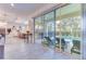 Covered patio with sliding glass doors, a view of the swimming pool and outdoor lounge chairs at 2537 Shanti Dr, Kissimmee, FL 34746