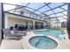 Screened in pool features a spa, tanning ledge, and lounge seating at 2537 Shanti Dr, Kissimmee, FL 34746