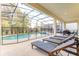 Inviting screened pool area with lounge chairs, table and chairs, perfect for outdoor relaxation and entertaining at 2537 Shanti Dr, Kissimmee, FL 34746