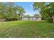Grassy backyard showcasing a well-maintained lawn and tree lined perimeter at 2753 Beckwith St, Deltona, FL 32738