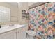 Neat bathroom featuring a vanity with sink, and a floral curtained shower at 2753 Beckwith St, Deltona, FL 32738