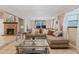 Comfortable living room featuring a brick fireplace, large sofa, and stylish decor at 2753 Beckwith St, Deltona, FL 32738